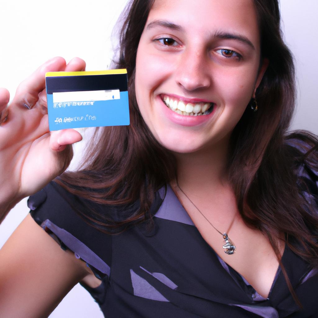 Person holding credit card, smiling