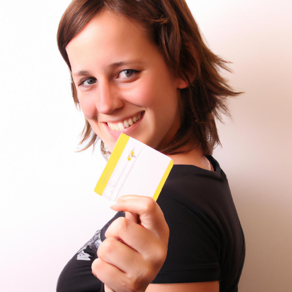 Person holding credit card, smiling