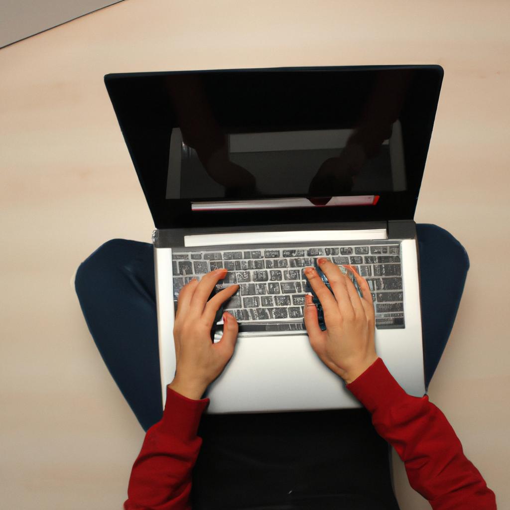 Person using laptop in room